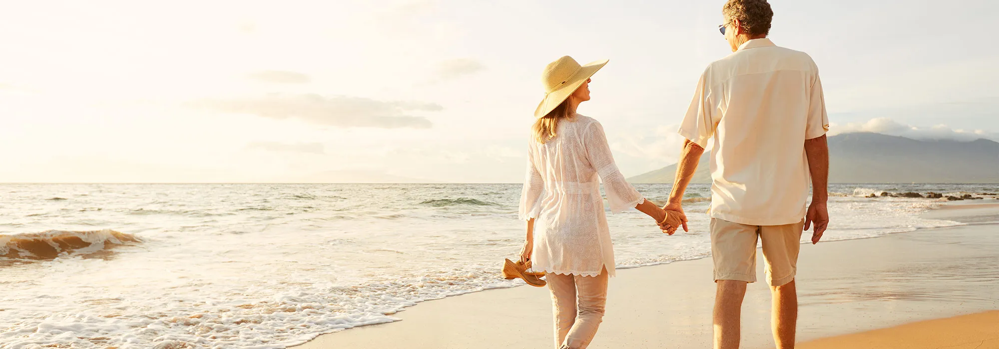 happy couple walking on beach together